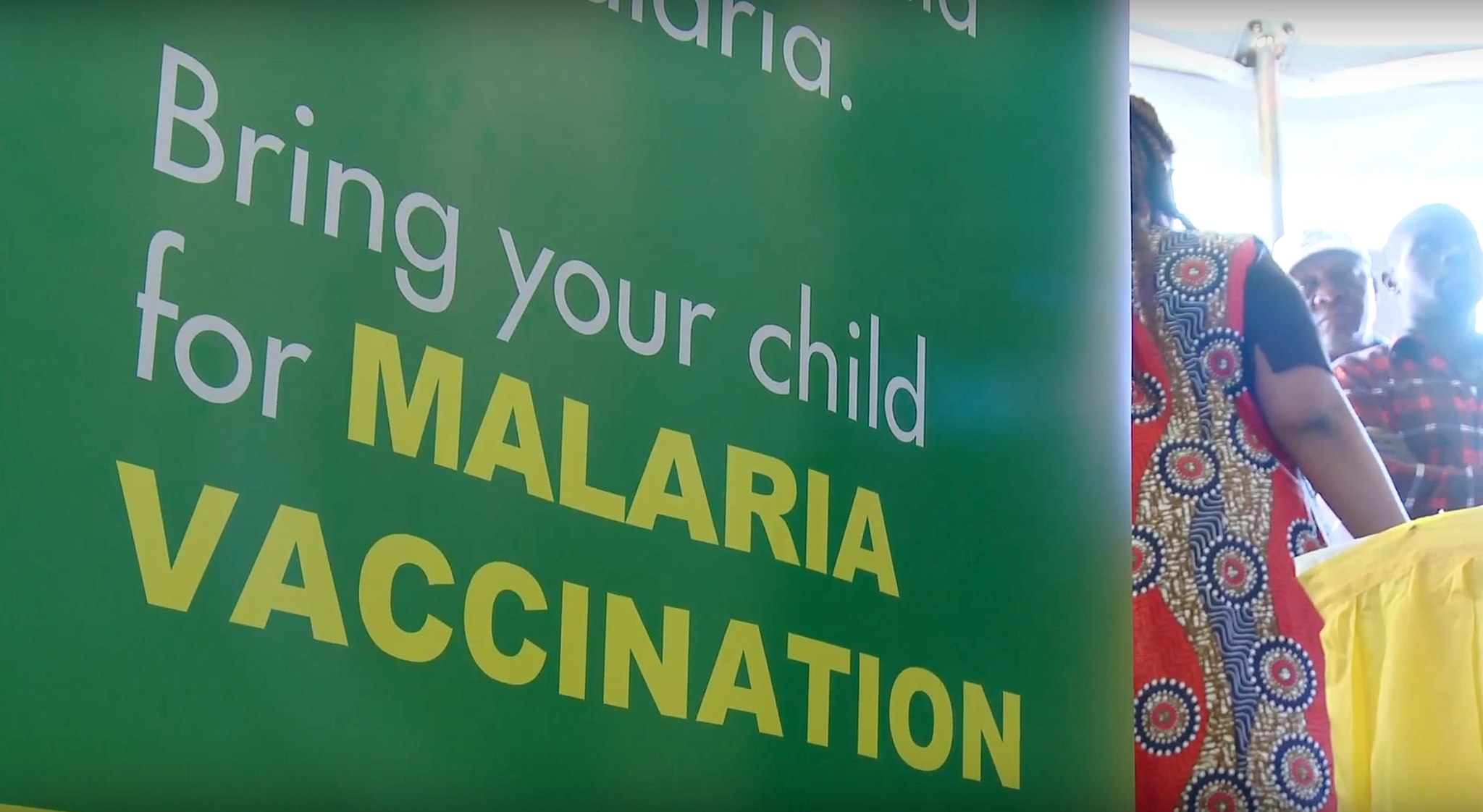 Photograph of sign saying 'bring your child for malaria vaccine'
