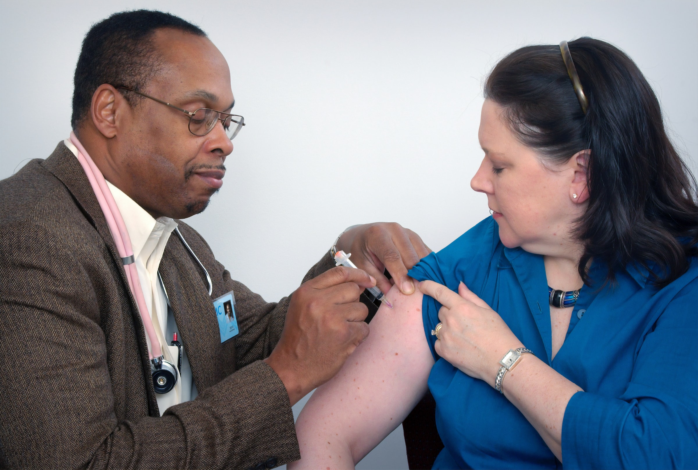 Doctor vaccinating person in right arm