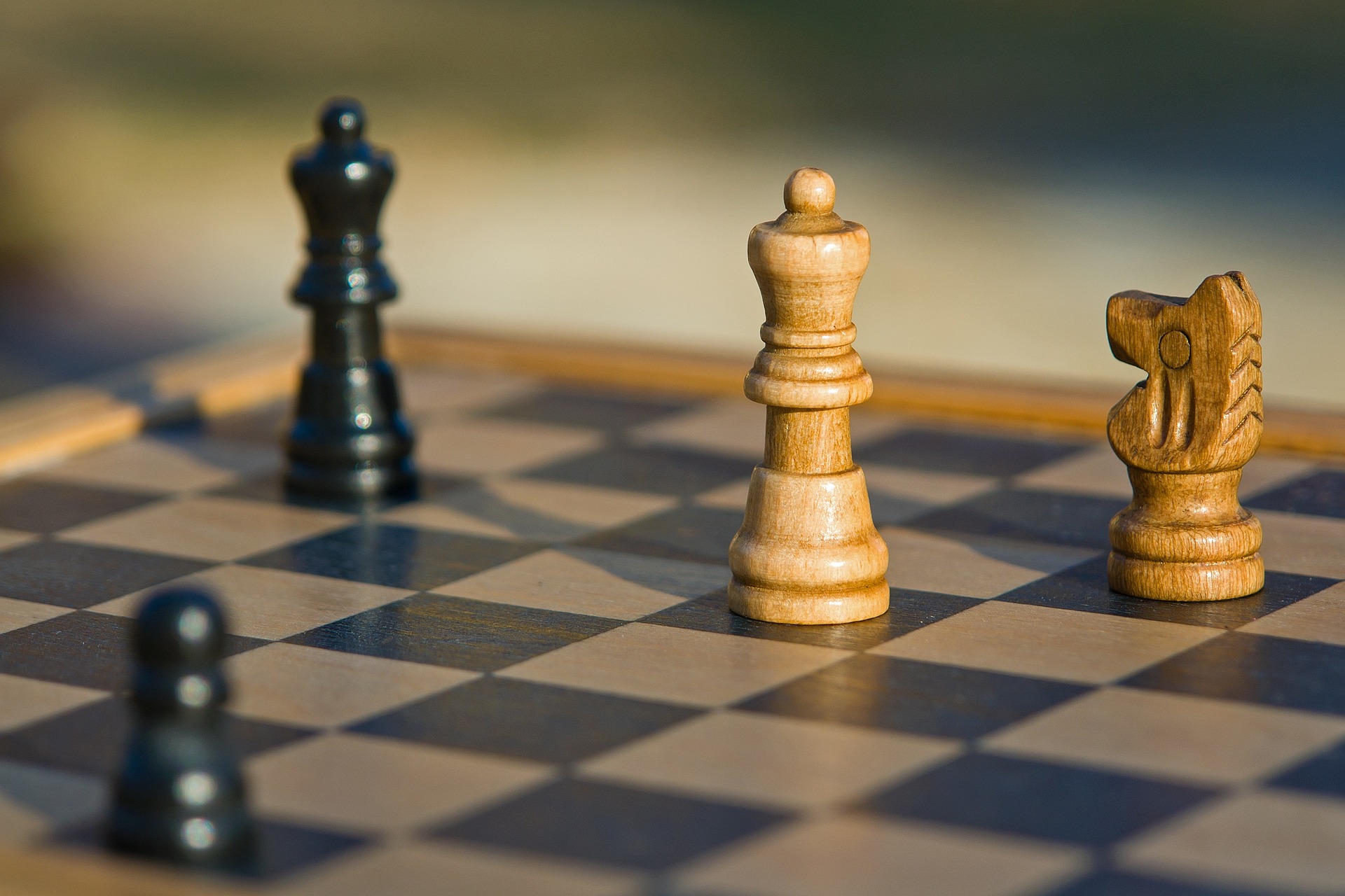 Wooden chess board with black and white pieces