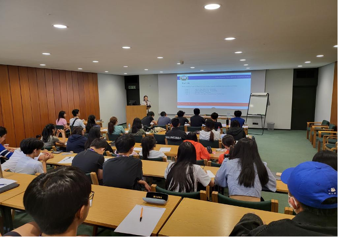 A lecture theatre with students attending a lecture.