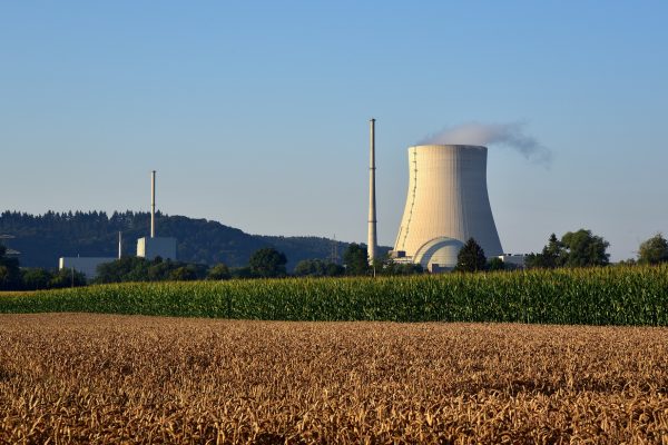 Nuclear myth-busting: A perspective on nuclear energy from Eugene Shwageraus A nuclear power plant with a blue sky and field in foreground.