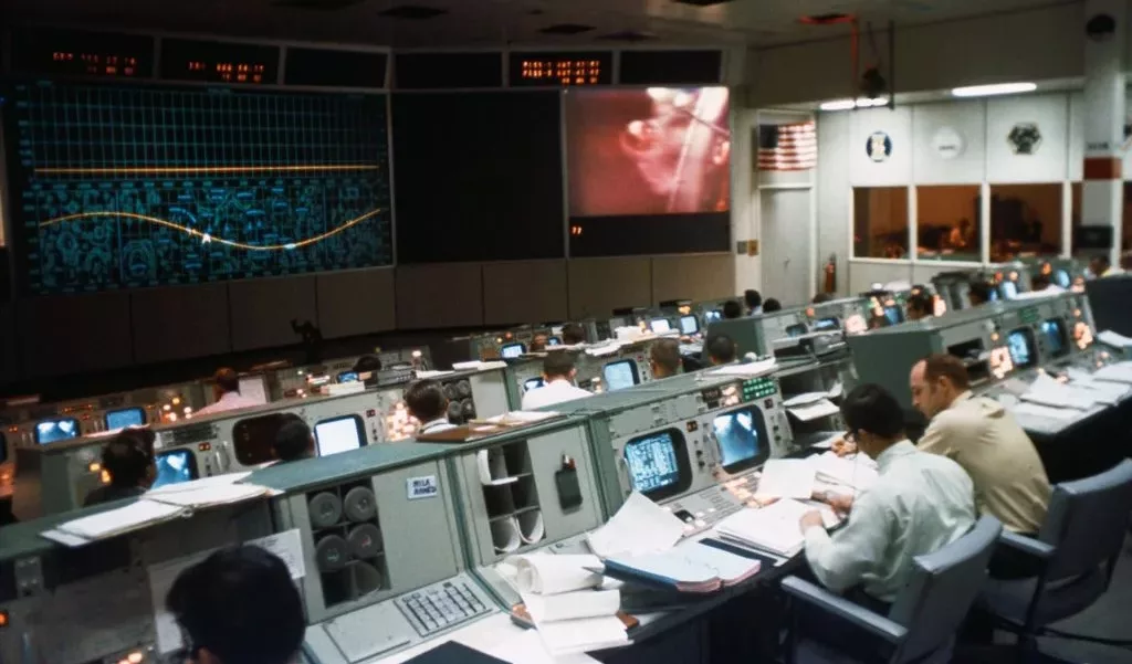 Apollo crew in the mission operation control room