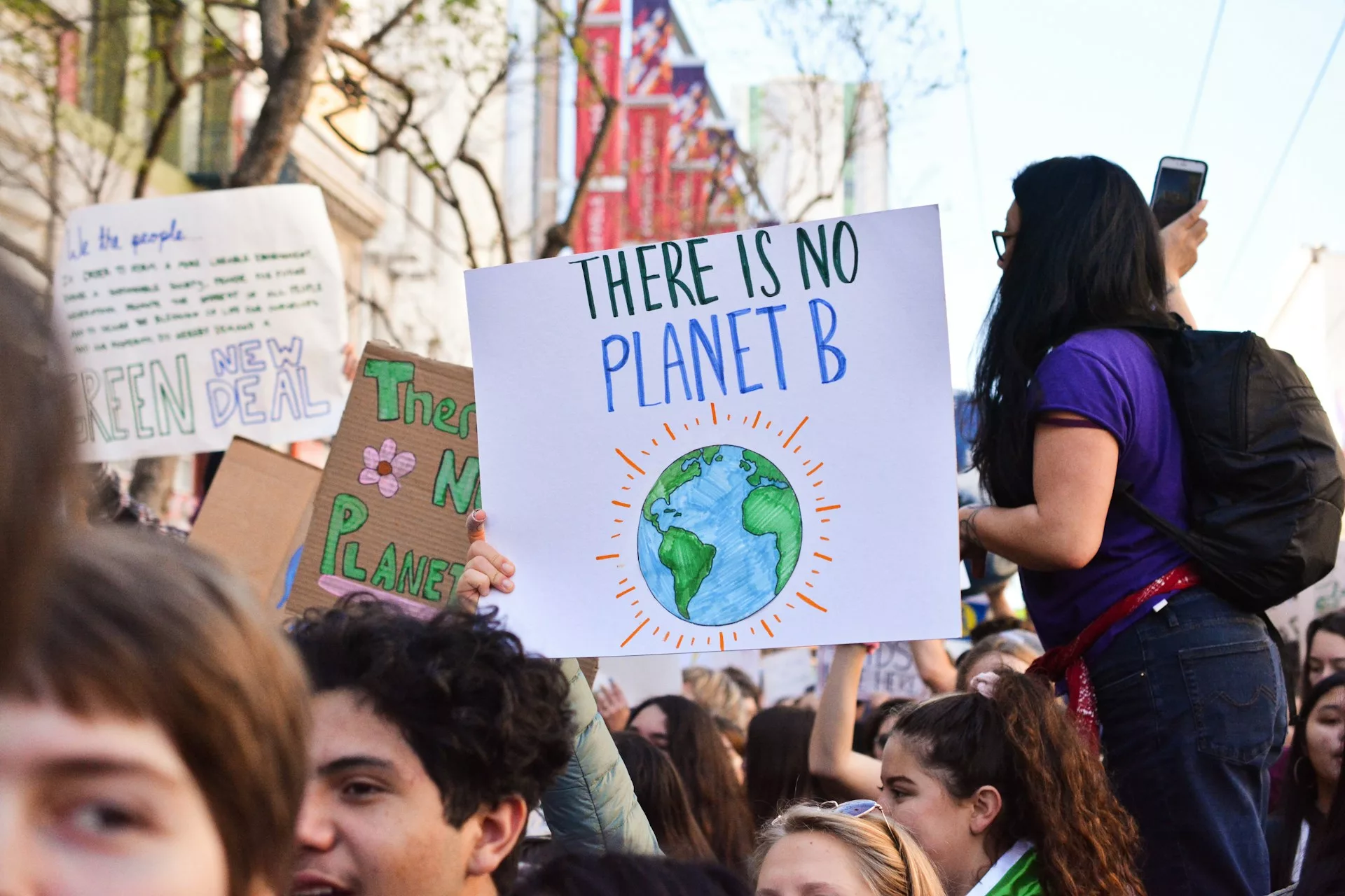 protester holding sign saying 'there is no planet B'