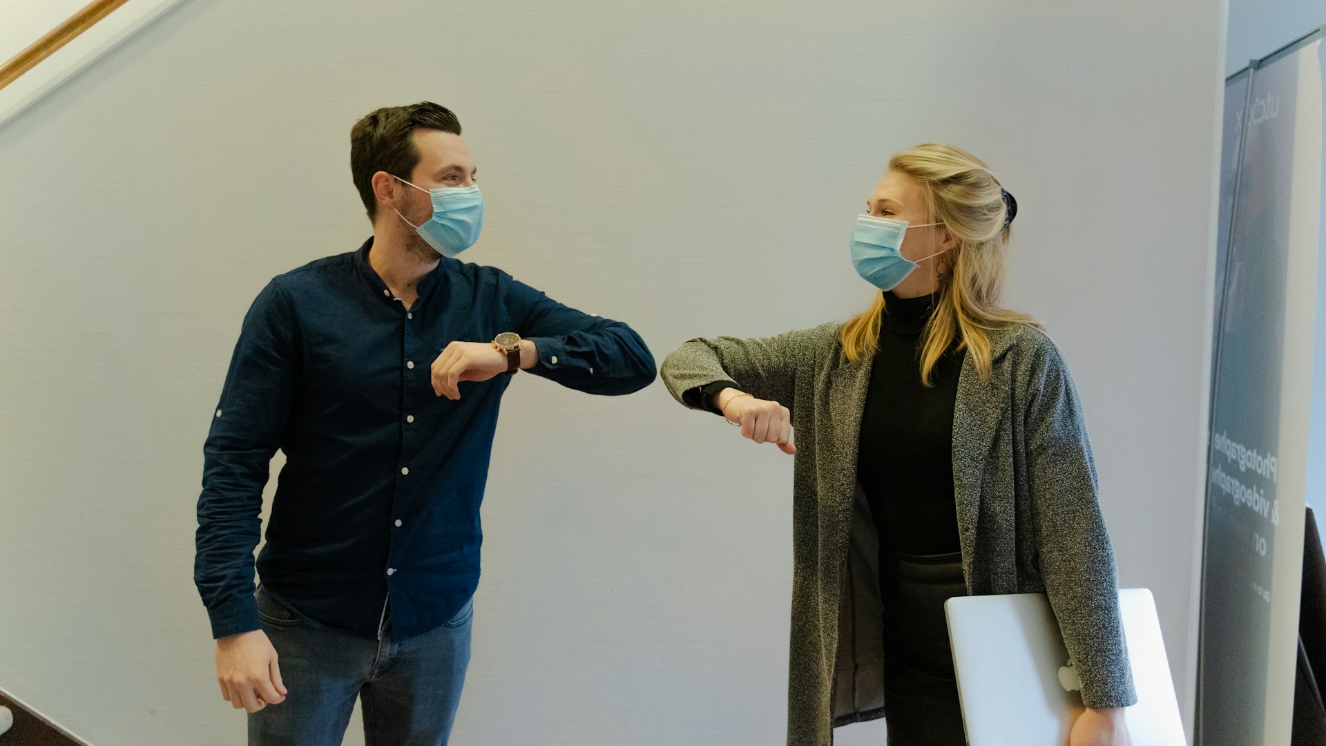 two people touching elbows during the pandemic